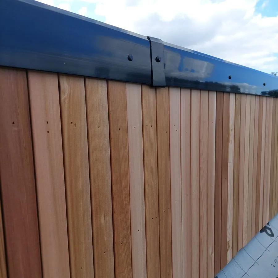 Cedar cladding beneath a new black fascia and gutter